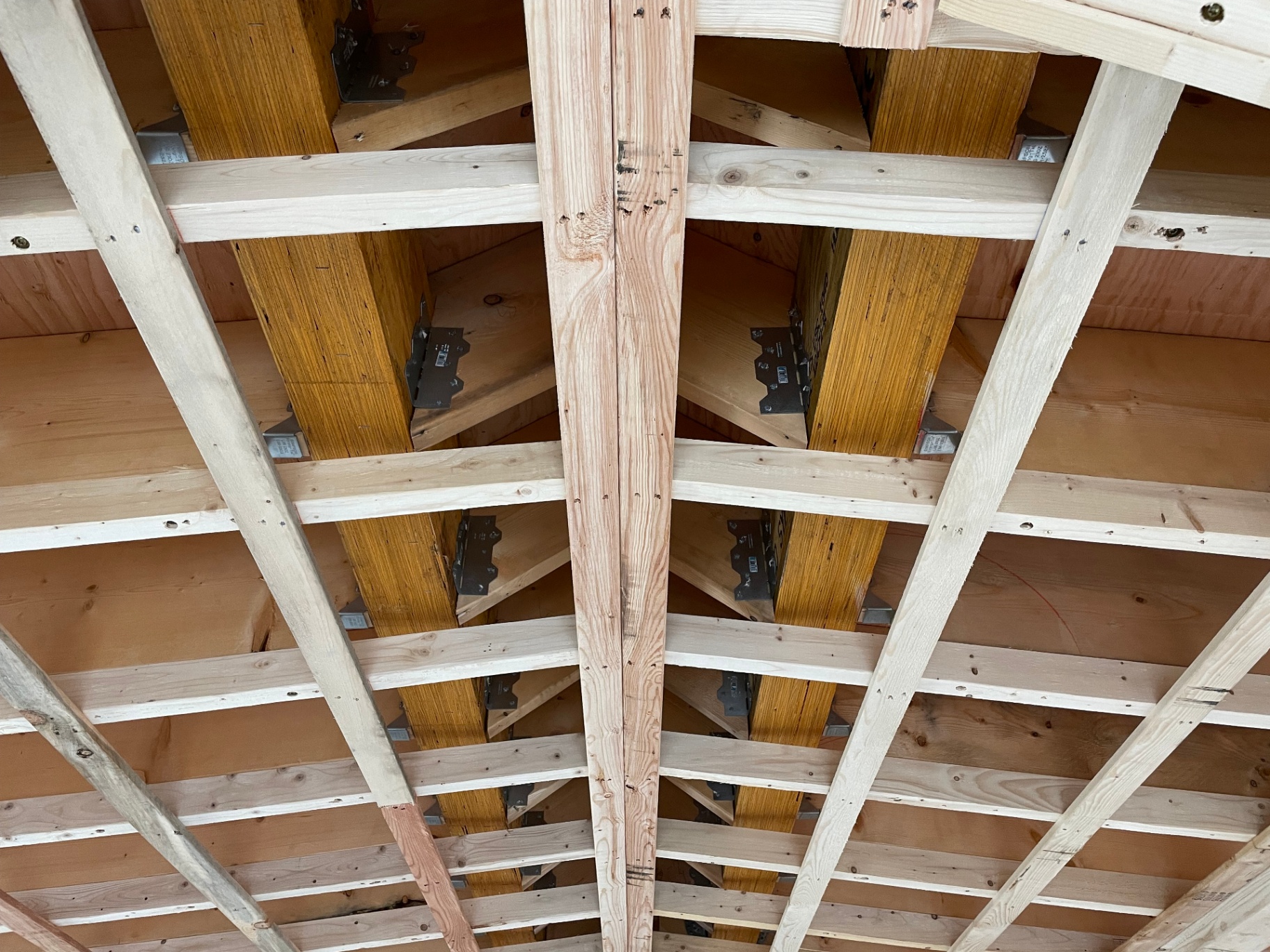Detail of engineered roof rafters with structural connectors and ridge beam
