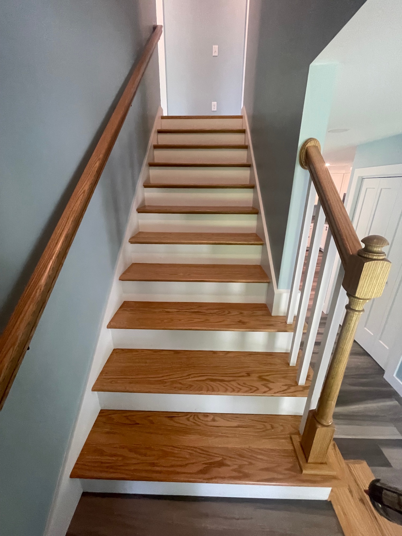 Oak staircase with turned newel post and painted risers