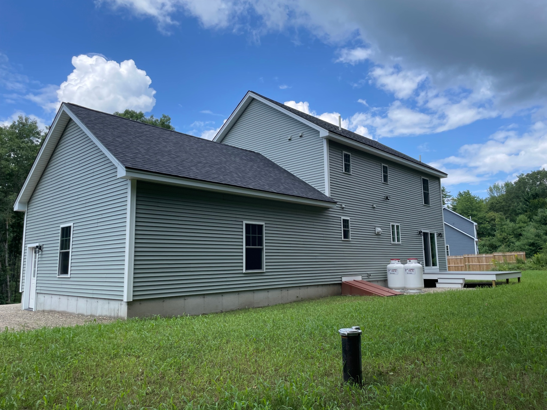 Rear exterior of the Springvale spec home with attached deck and walk-out basement