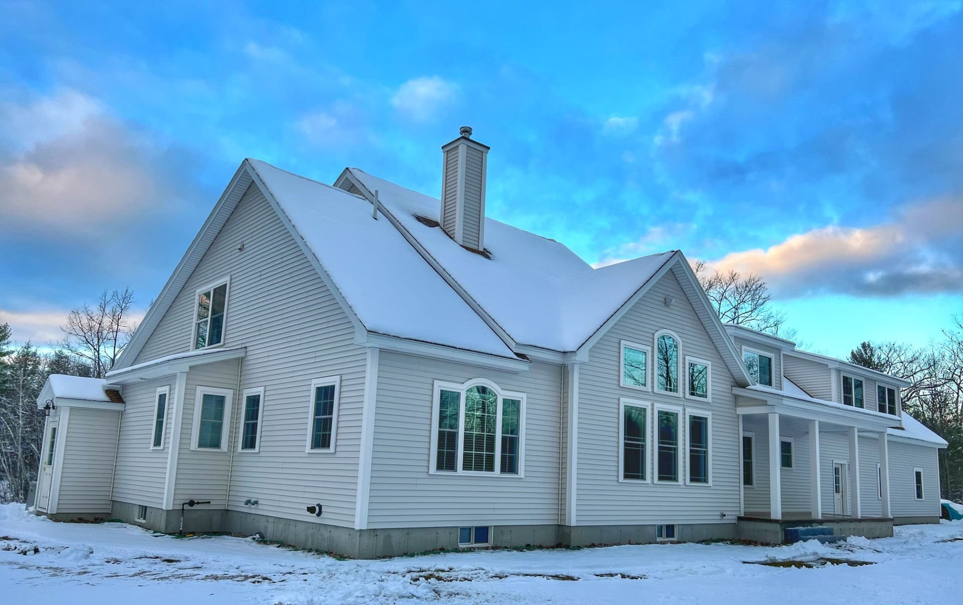 Side elevation showing cathedral great-room windows and chimney