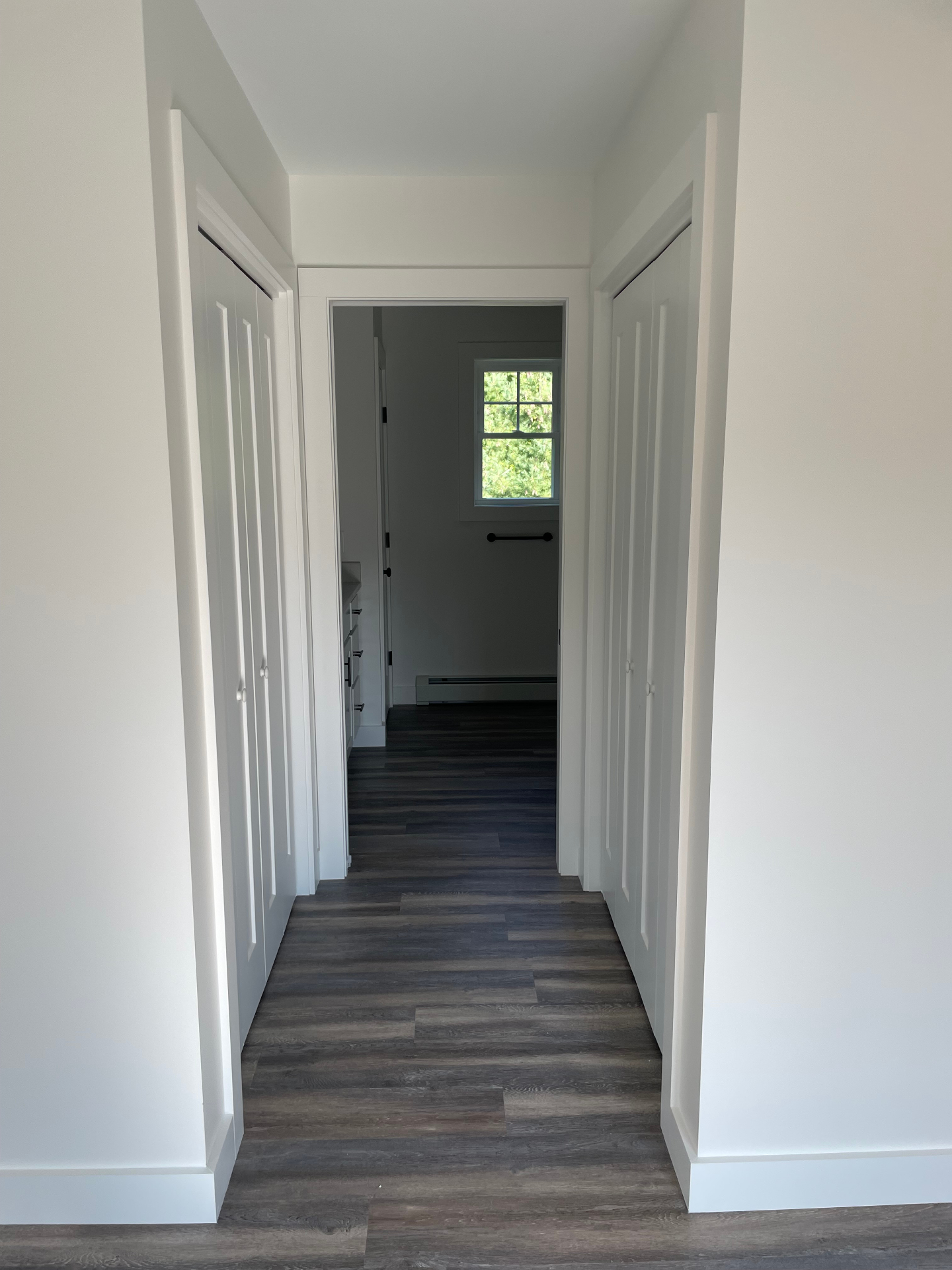Upstairs hallway with closets and natural light