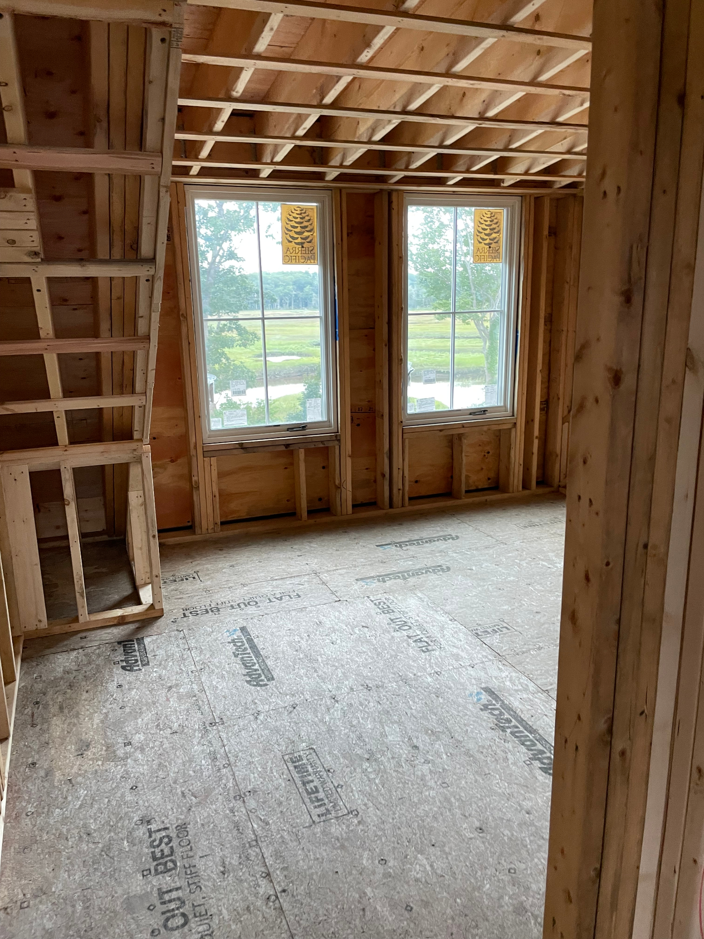 Stick-framed bedroom with Sierra Pacific windows overlooking the Biddeford Pool marsh