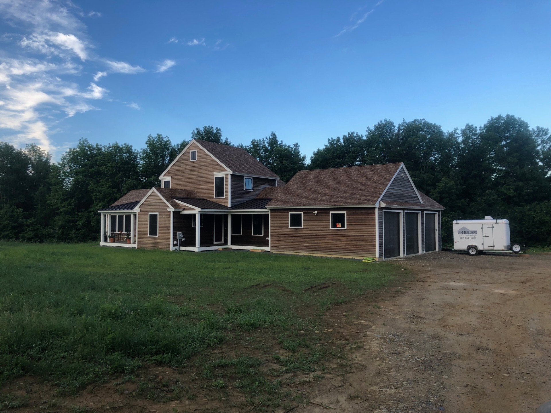 Farmhouse at golden hour with attached garage