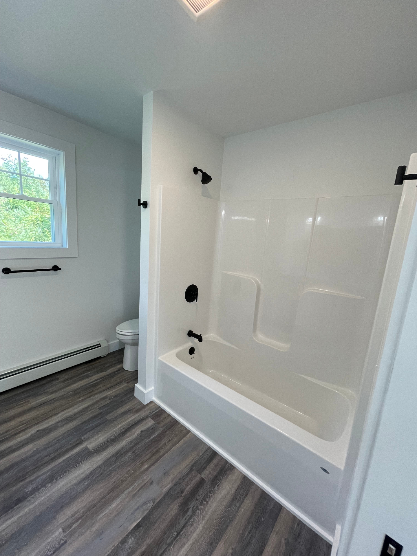 Full bathroom with tub-shower combo and matte black hardware