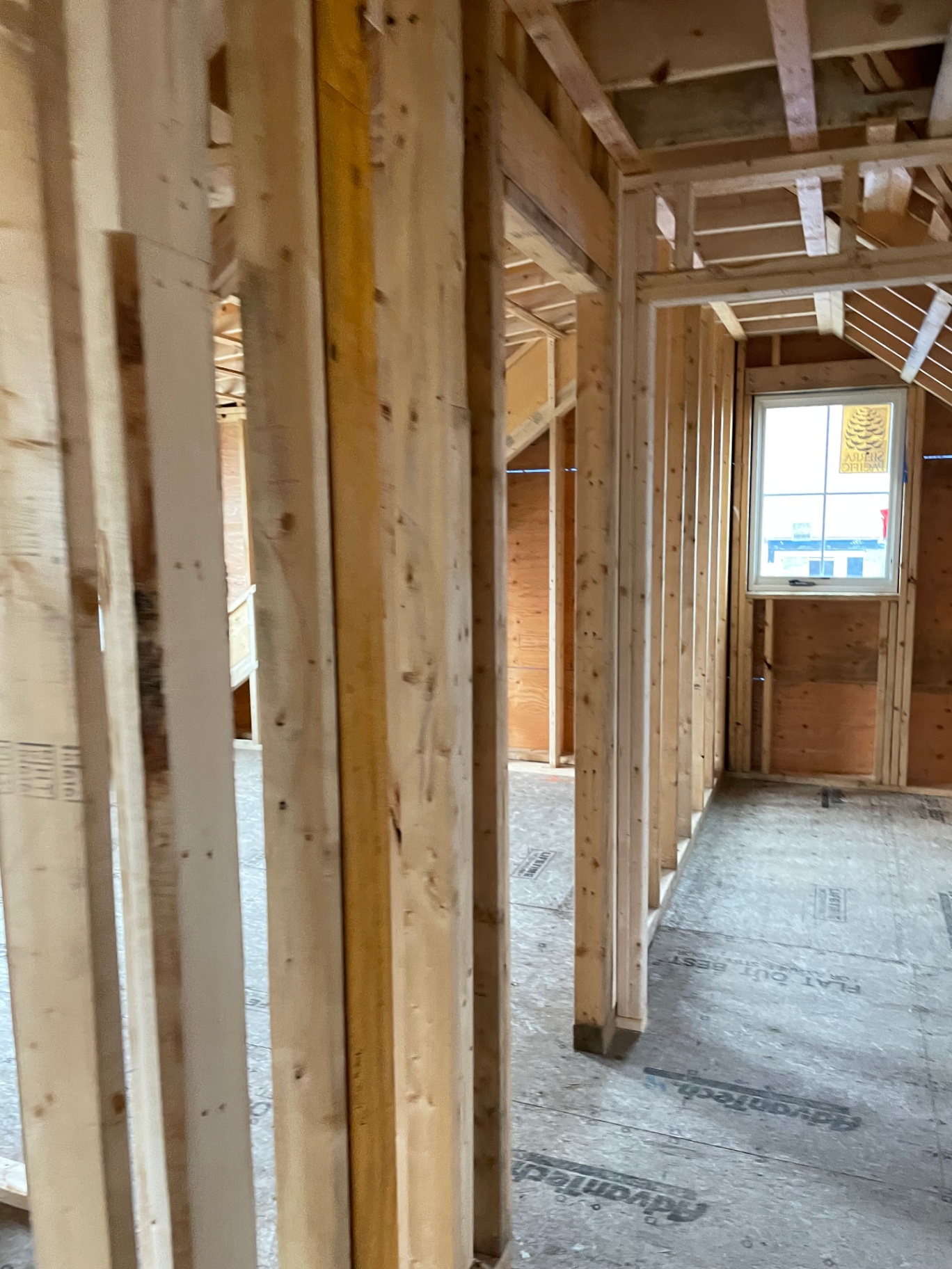 Framed upstairs hallway with Sierra Pacific dormer window and stud walls